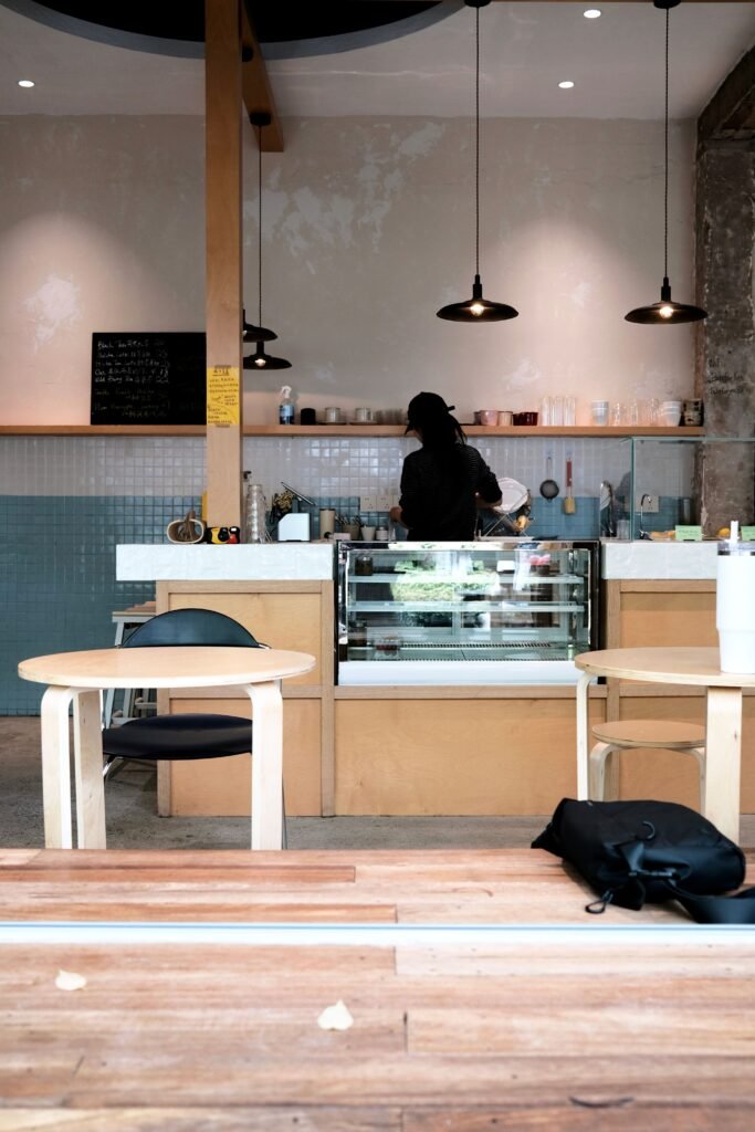 Warm interior of a bustling cafe in Suzhou, China with a barista at the counter.